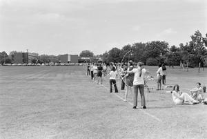 Primary view of object titled '[Students at Lamar University Practicing Longbows]'.