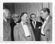 Photograph: [Lamar Fleming in conversation with unidentified men]