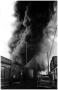 Photograph: [The Damron Hotel Fire, 16 of 21:  Black Smoke Billowing Over Busines…