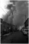 Photograph: [The Damron Hotel Fire, 15 of 21:  Passenger Cars on a Back Street]