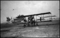 Primary view of [Photograph of Men and Biplane]
