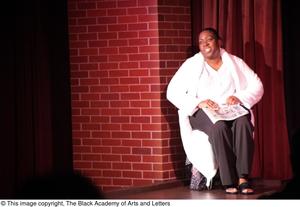 Primary view of object titled '[Performer in bathrobe speaking on stage]'.
