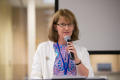 Photograph: [Karen DeVinney Speaking into Microphone at Conference]
