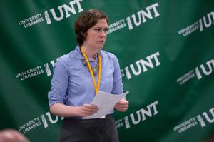 Primary view of object titled '[Sarah Lippincott in front of UNT Banner]'.