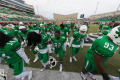 Photograph: [Mean Green Football players on field]