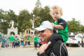 Photograph: [Grandparent with Grandchild at Homecoming Parade]