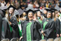 Photograph: [Masters Graduate Student Waving to Family and Friends at Commencemen…