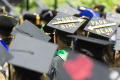 Photograph: [Decorated Graduation caps at commencement ceremony]