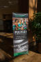 Photograph: [Promotional standing banner at conference]