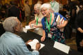Photograph: [Attendee having book signed]