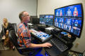 Photograph: [NT Daily TV team member sitting at control board]