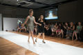 Photograph: [Two fashion design students walking on runway]