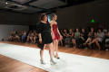Photograph: [Fashion design student with model during ArtWear runway]