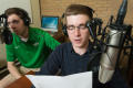 Primary view of [Two NT Daily Radio students sitting at a desk]