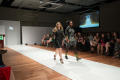Photograph: [Fashion design student walking down runway with model]