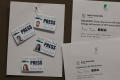 Photograph: [Four staff member IDs and two twitter printouts]
