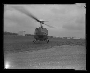 Primary view of object titled '[Photograph of a UH-1B Iroquois helicopter lifting off the ground, 3]'.