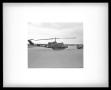 Photograph: [Photograph of a side view of a UH-1C Iroquois helicopter facing the …