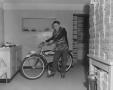 Photograph: [Portrait of Teenage Boy Standing Next to a Bicycle]