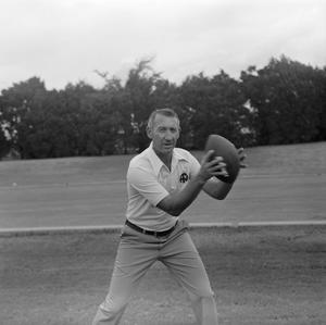 Primary view of object titled '[Coach holding a football, 3]'.