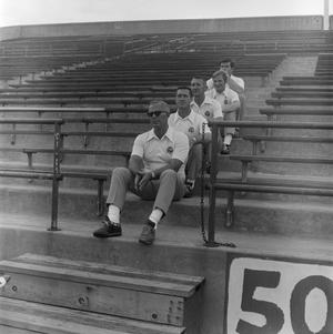 Primary view of object titled '[Football coaches sitting in a line, 2]'.