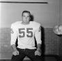 Photograph: [Football player sitting on a bench, 6]
