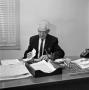 Photograph: [Dr. Alex Dickie sitting at desk, 1 of 4]