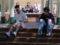 Photograph: [Actors sitting on pavilion steps]