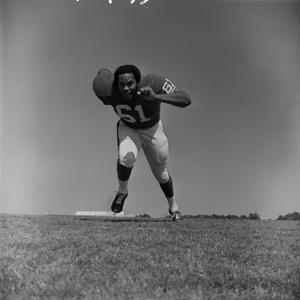Primary view of object titled '[Football player #61, Glen Holloway, charging angled down field]'.
