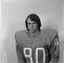 Photograph: [Football player sitting for a portrait, 19]