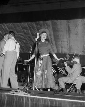 Primary view of object titled '[Singer on Stage with Musicians]'.