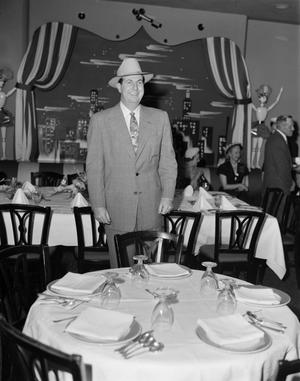 Primary view of object titled '[Don McNeill Standing Behind a Table]'.