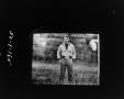 Photograph: [Man standing in a field]