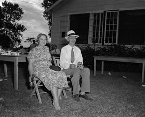 Primary view of object titled '[Man and woman sitting outdoors]'.