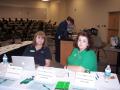 Photograph: [Cindy Woods and Teresa Walls at sign-in table]