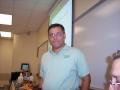 Photograph: [Dr. John Quintanilla in front of whiteboards]