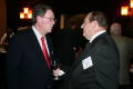Photograph: [Rollie Hyde and man chatting at TDNA conference]