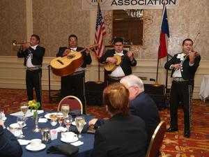 Primary view of object titled '[Mariachi band performing for guests at dinner]'.