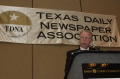Photograph: [Donnis Baggett speaking into mic at TDNA conference]