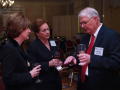 Photograph: [Charles Moser conversing with two women at TDNA dinner]