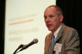 Photograph: [Bob Montgomery speaking into microphone during TDNA conference]