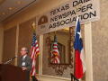 Primary view of [Gary Borders standing at podium giving speech at TDNA meeting]