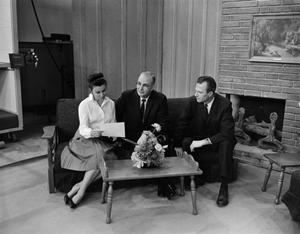 Primary view of object titled '[A WBAP employee and the Kembel Brothers on set]'.