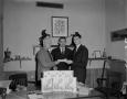 Photograph: [Men displaying Charmin and Puffs products]
