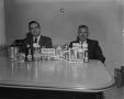 Photograph: [Two men sitting at a table with Colgate products]