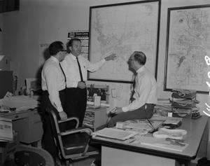 Primary view of object titled '[Men in office with market survey map]'.