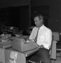 Photograph: [WBAP employee using a typewriter]