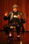 Photograph: [Photograph of director Melvin Van Peebles talking on stage]