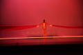 Photograph: [Photograph of a dancer on stage with red fabric draped over his shou…