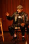 Thumbnail image of item number 1 in: '[Photograph of director Melvin Van Peebles talking on stage at a film festival]'.